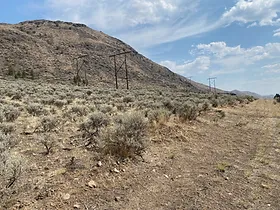 Large hill overlooking sagebrush on a property in Walhachin